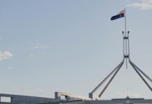 State government building with American flag, representing gubernatorial leadership and political authority