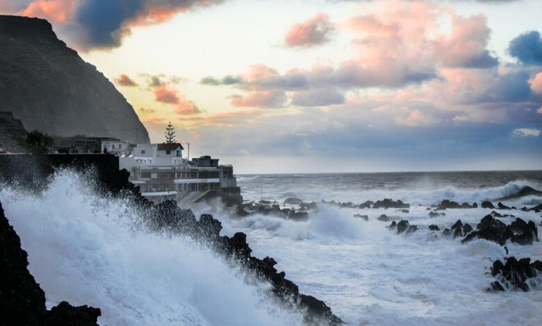 Coastal residential houses facing stormy weather conditions near the ocean