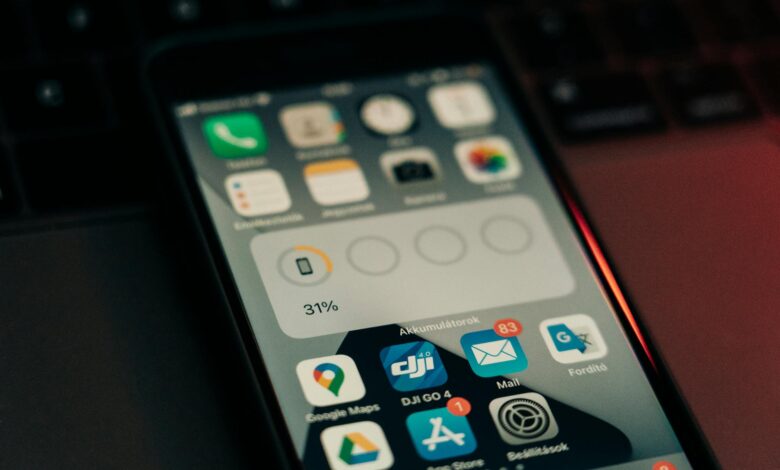 Person checking weather forecast on mobile phone displaying temperature and precipitation data