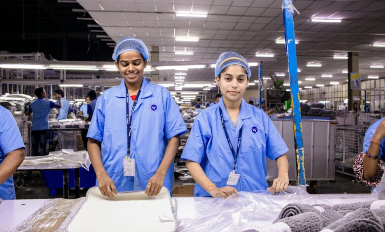 Industrial workers operating manufacturing equipment in a modern processing facility