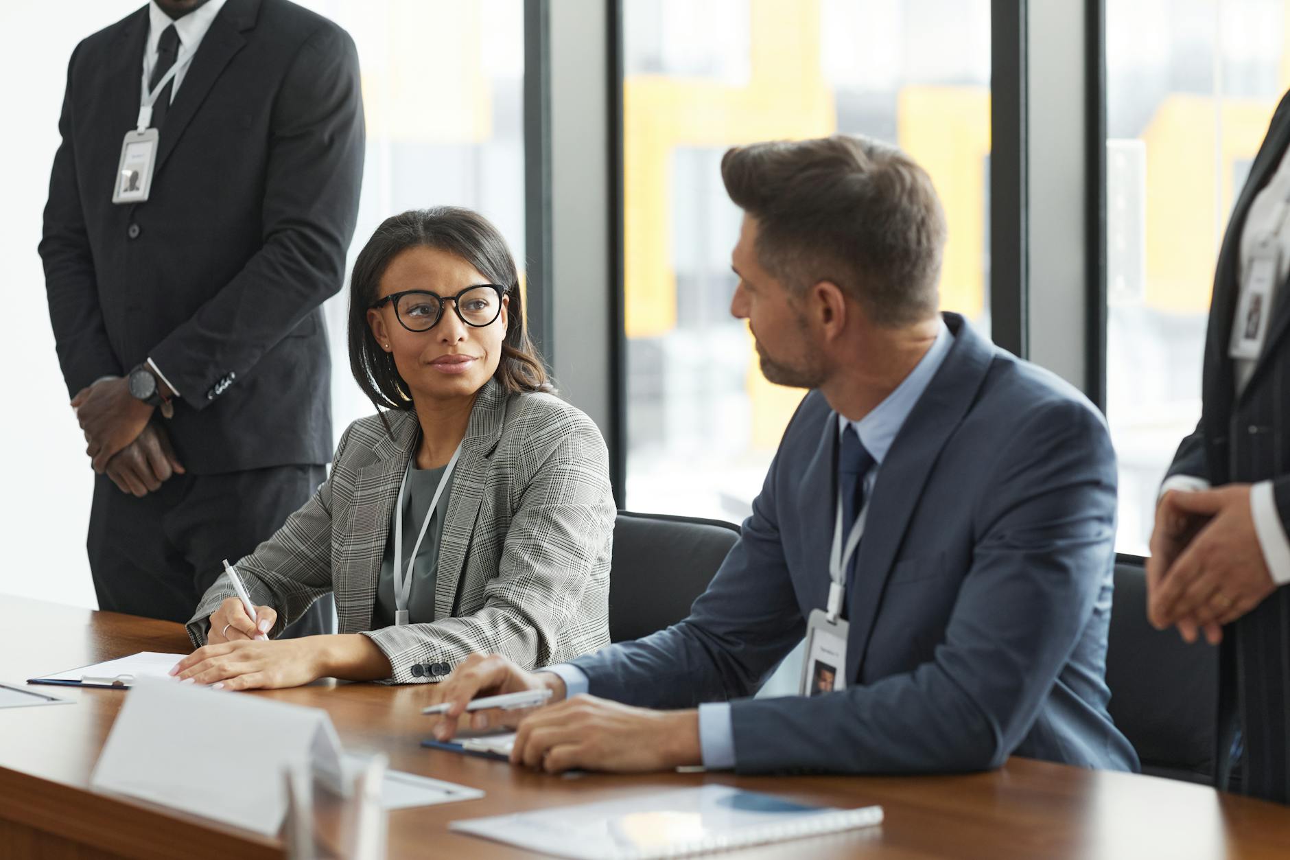 Professional business meeting with diverse group of people discussing around conference table