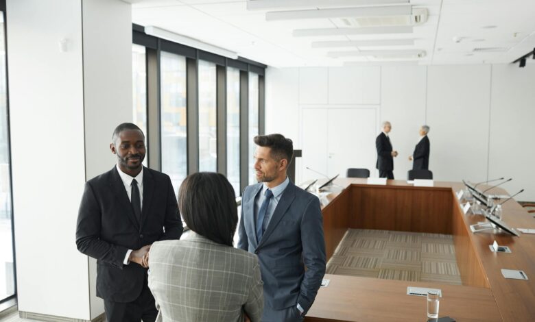 Professional business meeting with executives discussing strategy around conference table