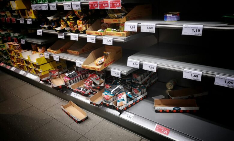 Modern grocery store shelves displaying various private label and name brand products side by side