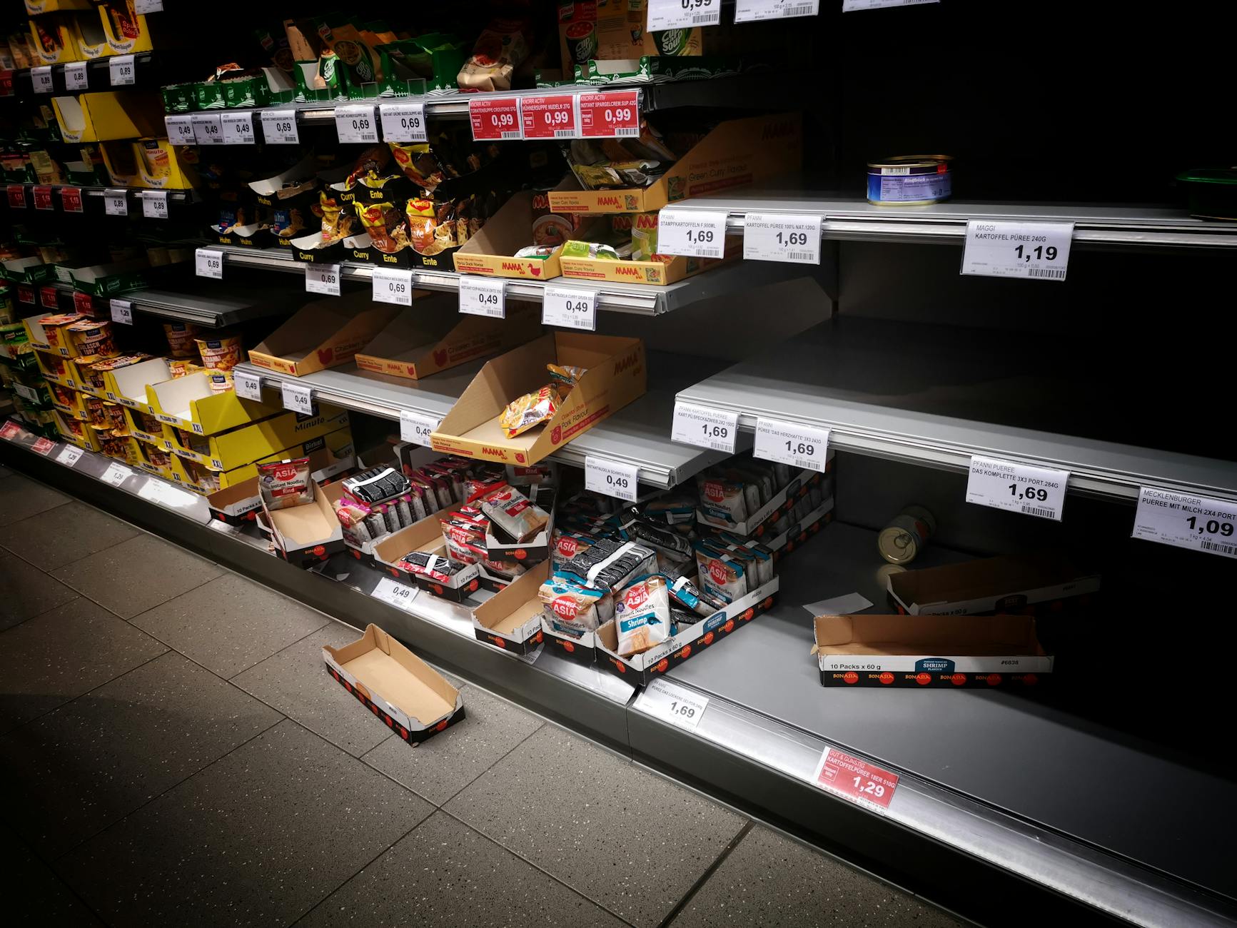 Modern grocery store shelves displaying various private label and name brand products side by side