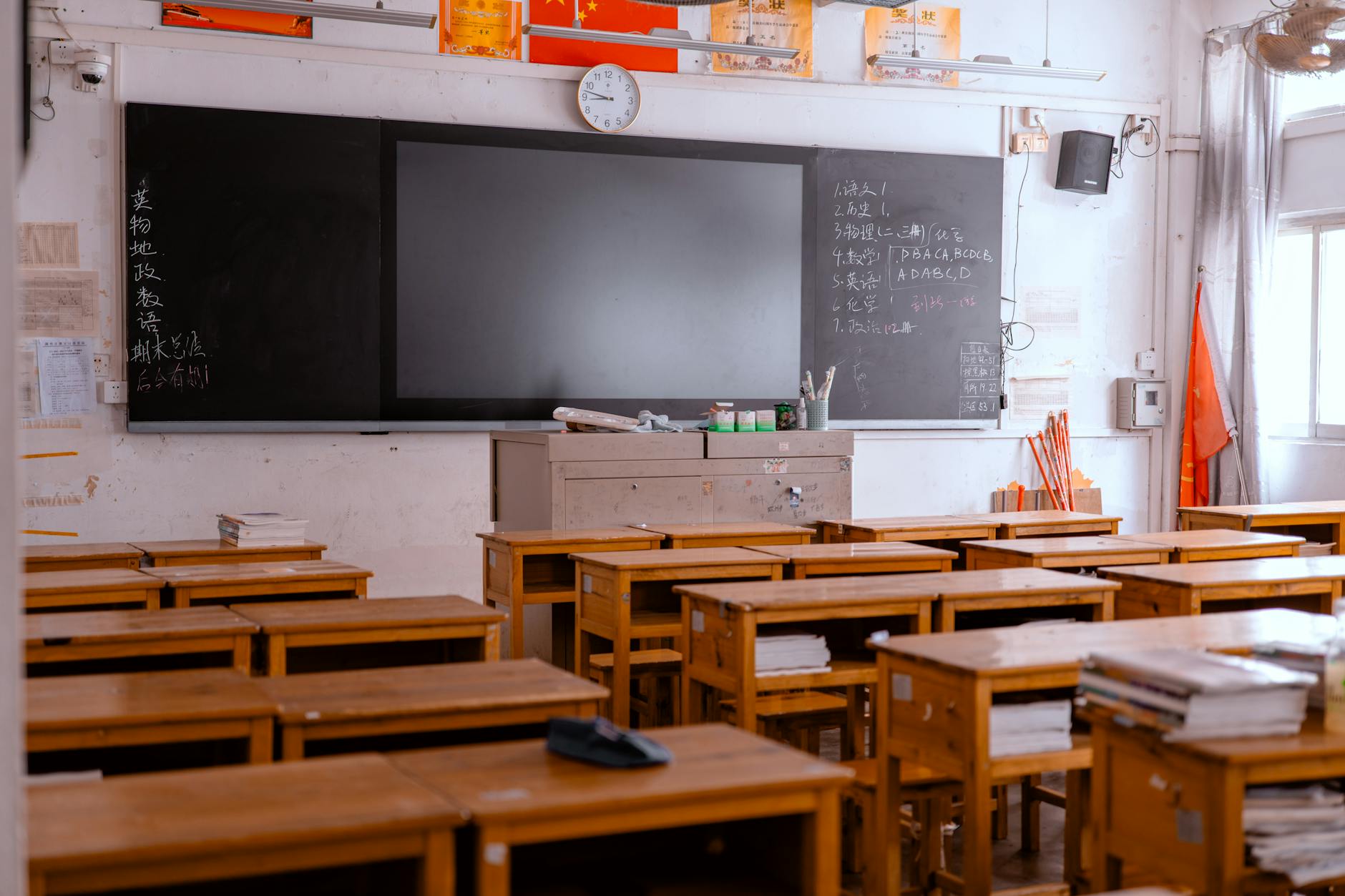 Empty elementary school classroom with desks and educational materials