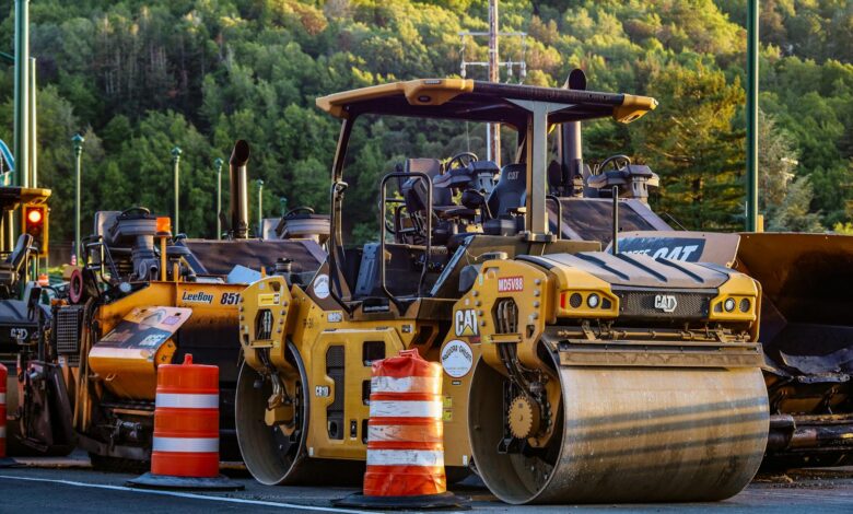 Highway construction with orange cones and work crews repairing road infrastructure