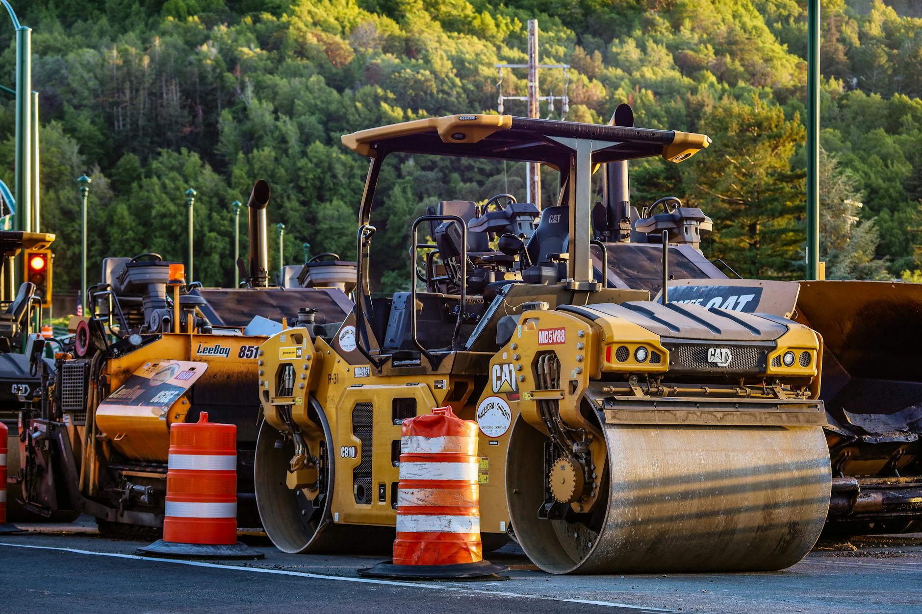 Highway construction with orange cones and work crews repairing road infrastructure