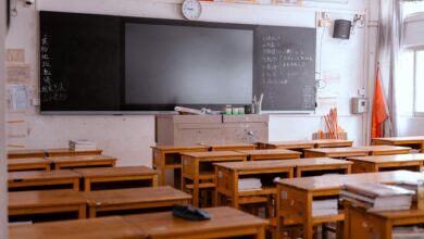 Empty classroom with rows of student desks highlighting teacher shortage crisis