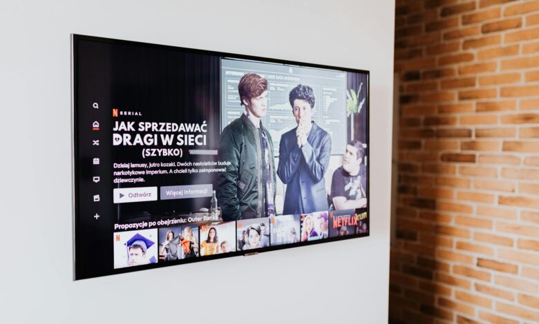 Person using streaming service on television screen with remote control