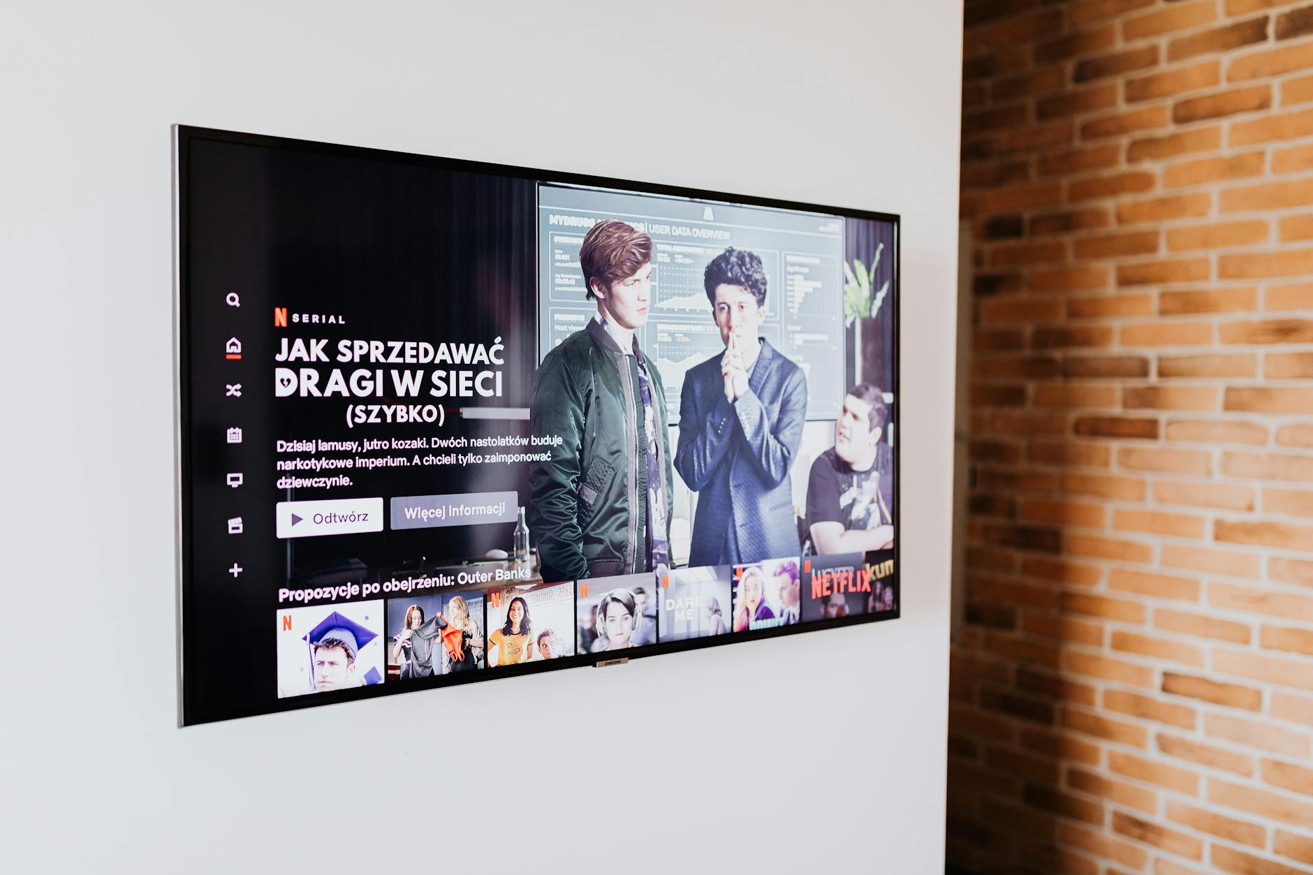 Person using streaming service on television screen with remote control