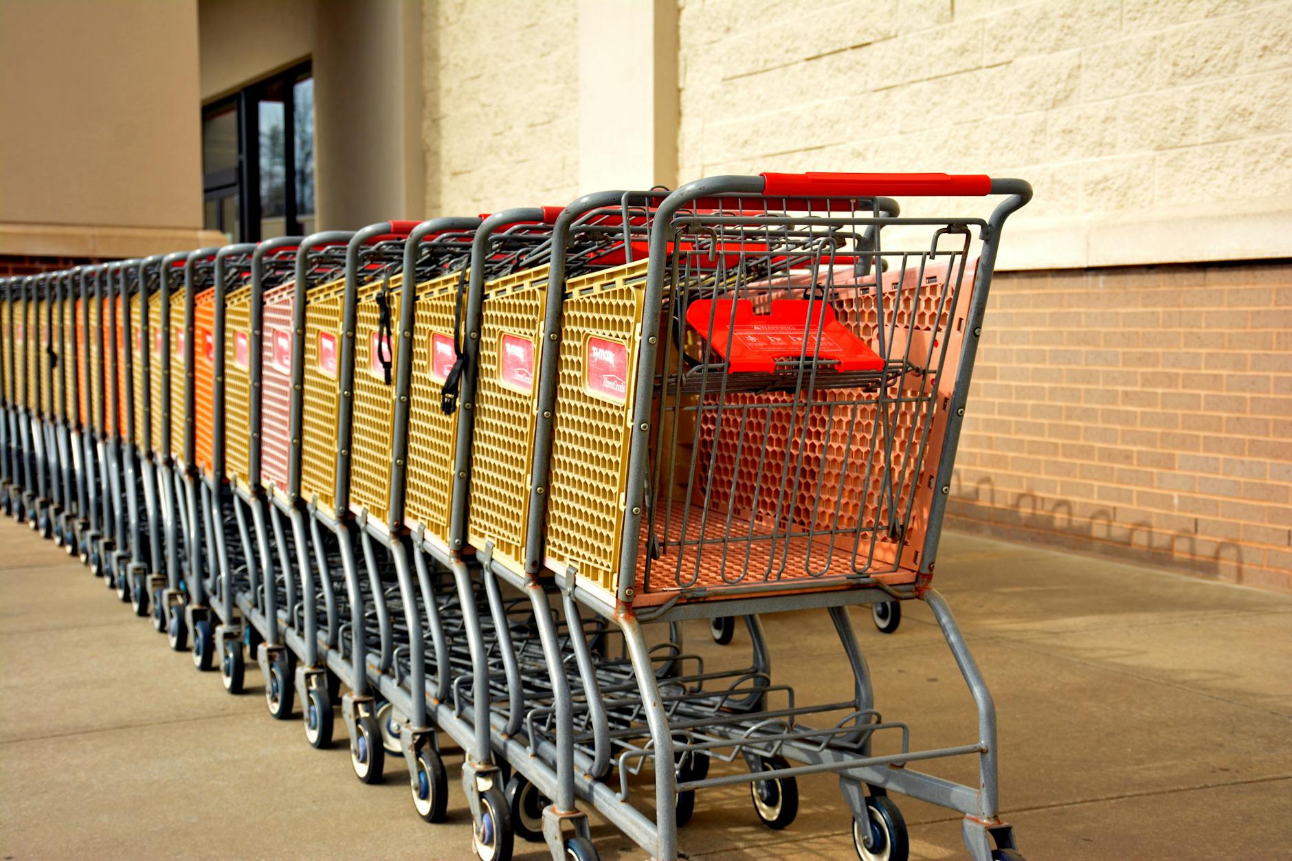 Shopping cart in grocery store aisle with shelves of products