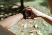 Person wearing fitness tracker on wrist showing sleep monitoring interface