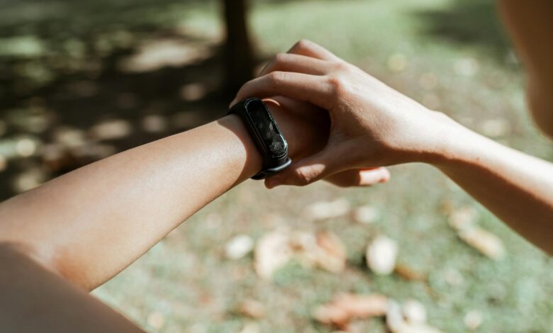 Person wearing fitness tracker on wrist showing sleep monitoring interface