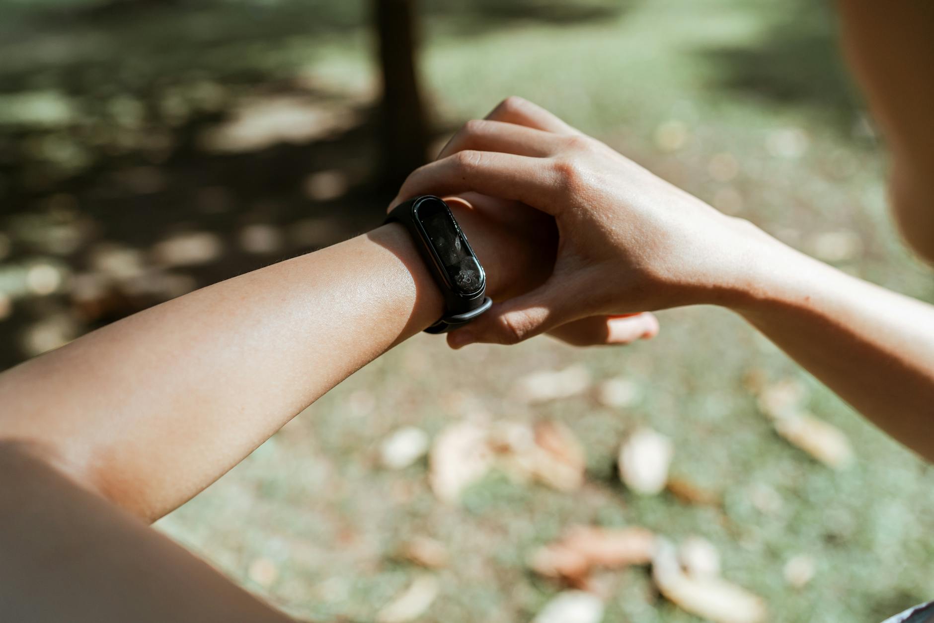 Person wearing fitness tracker on wrist showing sleep monitoring interface