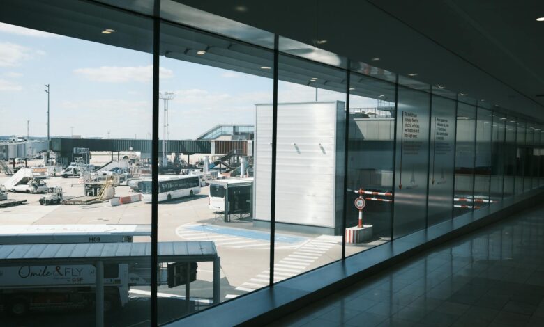 Modern airport terminal interior with travelers walking through departure area