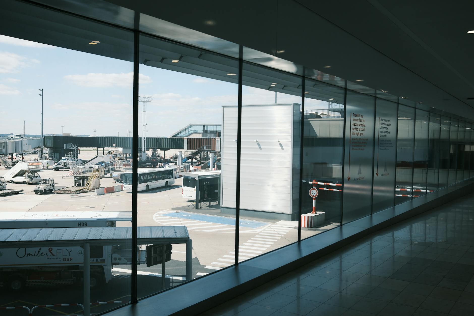Modern airport terminal interior with travelers walking through departure area