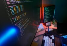 Modern newsroom with computers and monitors showing local news coverage and social media feeds