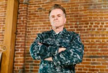 Professional headshot of a military veteran in business attire