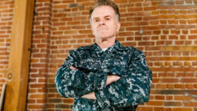 Professional headshot of a military veteran in business attire