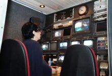 Modern television broadcasting studio with professional lighting and camera equipment