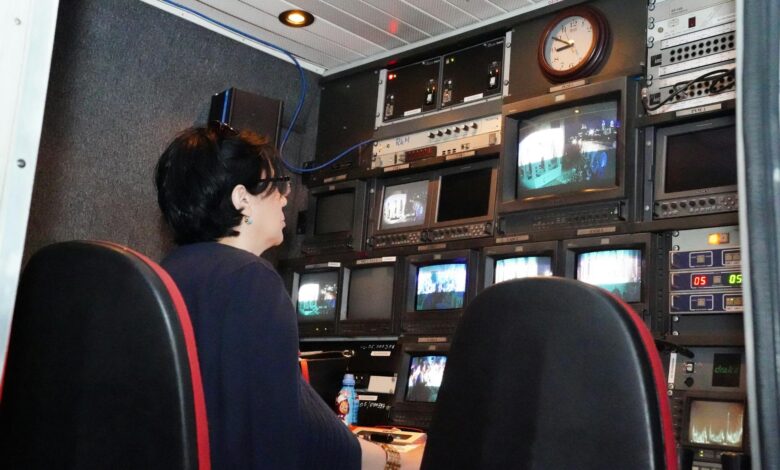 Modern television broadcasting studio with professional lighting and camera equipment