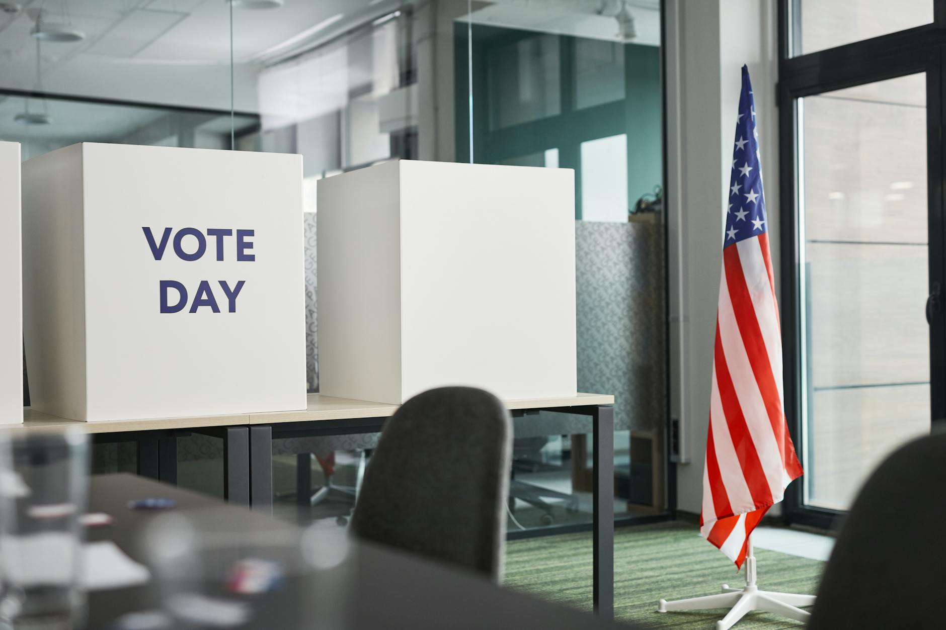 Voter at polling station casting ballot in voting booth