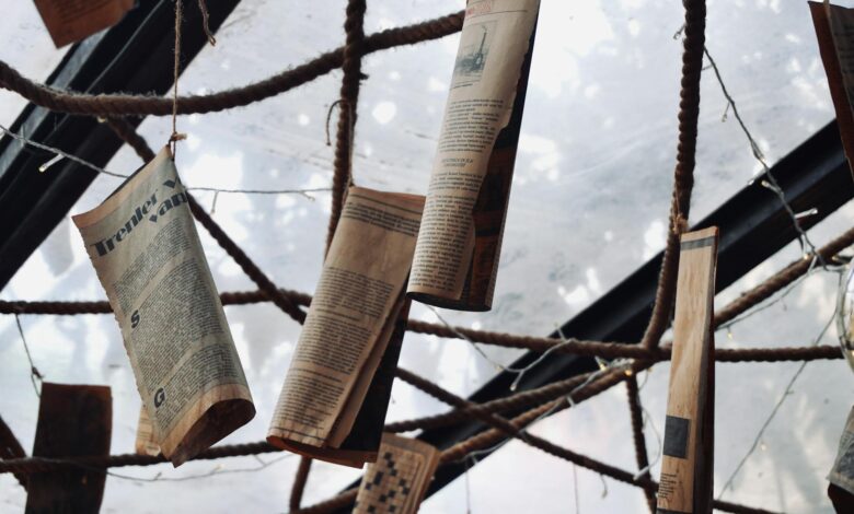 Large newspaper printing press with freshly printed newspapers coming off the production line