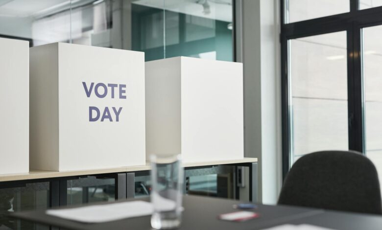 Person casting ballot at voting station during election