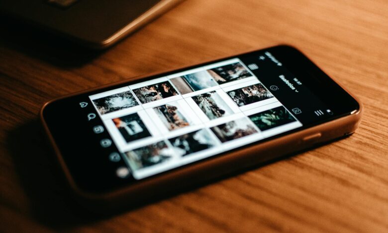 Person holding smartphone displaying social media interface with engagement metrics and follower counts