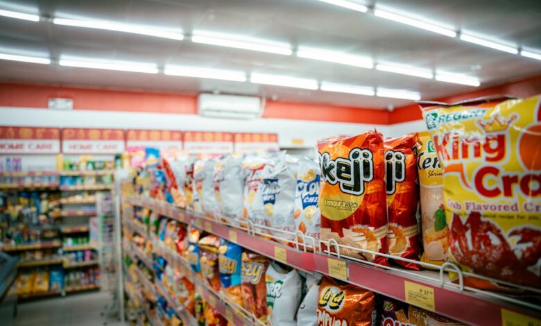 Interior view of traditional grocery store with shopping carts and product aisles