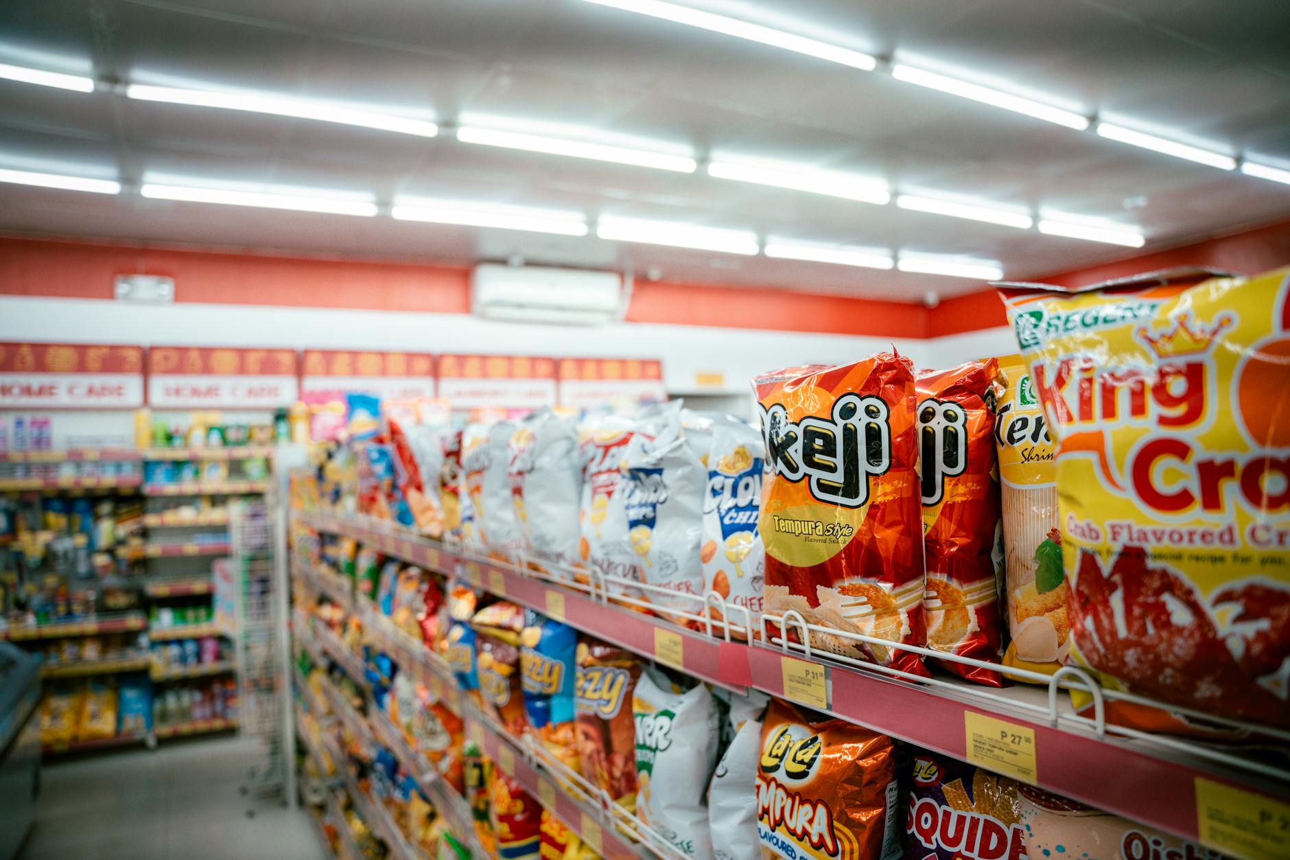 Interior view of traditional grocery store with shopping carts and product aisles