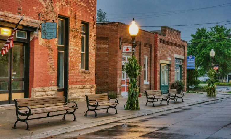 Main street of a small American town with local businesses and pedestrians