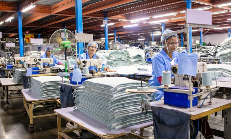 Manufacturing workers collaborating on production line in modern industrial facility