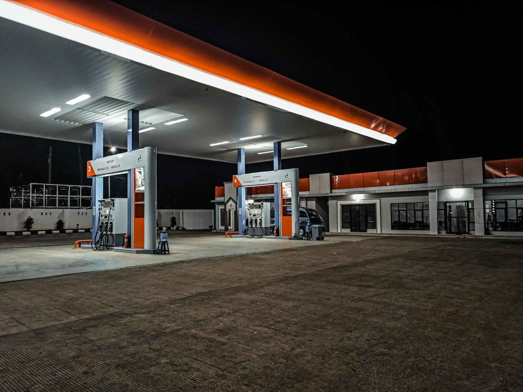 Modern gas station with fuel pumps and convenience store building