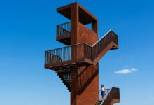 "Fire watch tower against blue sky used for bushfire monitoring and early detection"
