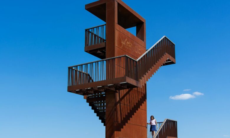 "Fire watch tower against blue sky used for bushfire monitoring and early detection"
