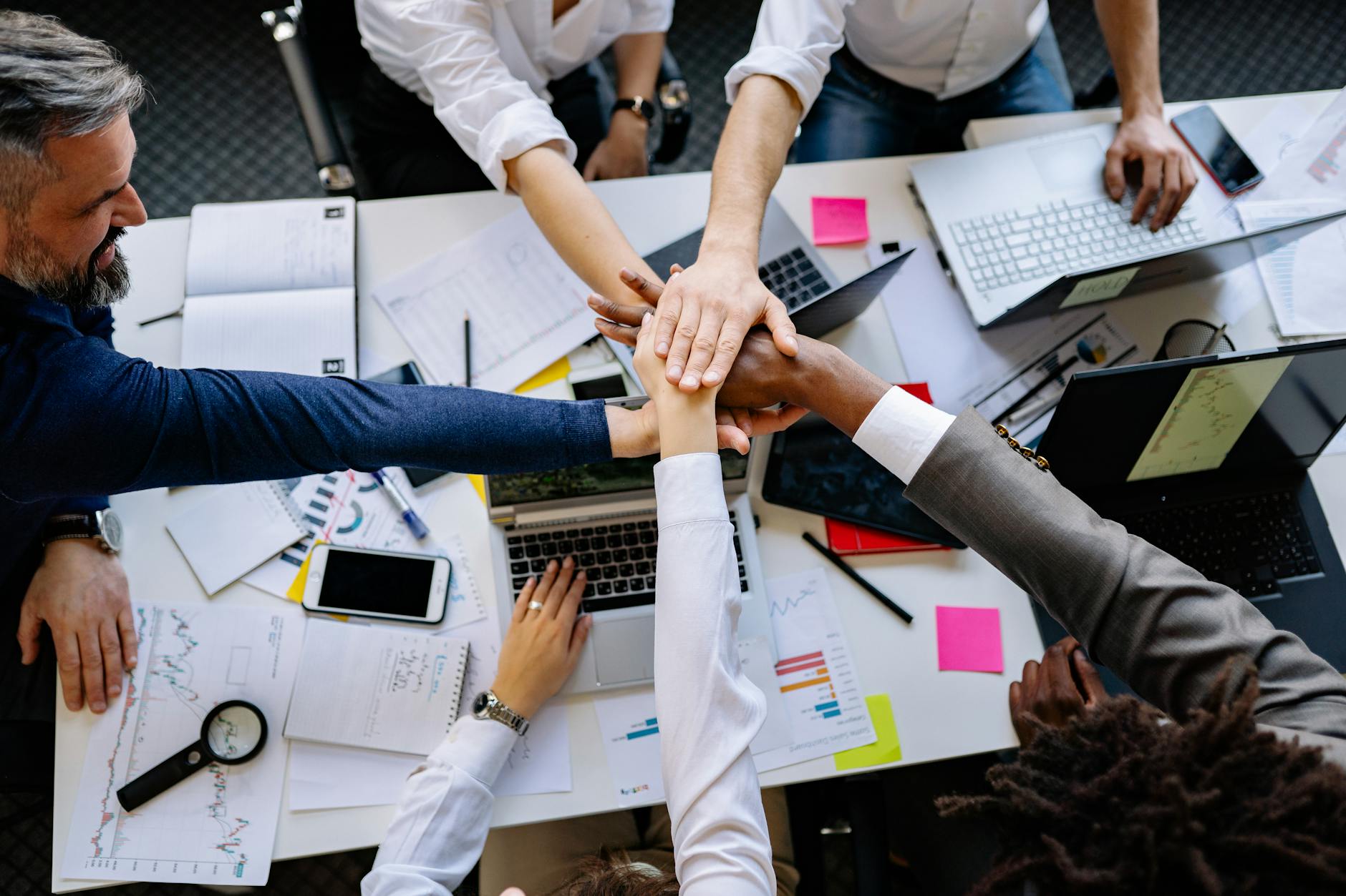 Group of diverse professionals collaborating around a conference table in a modern office setting