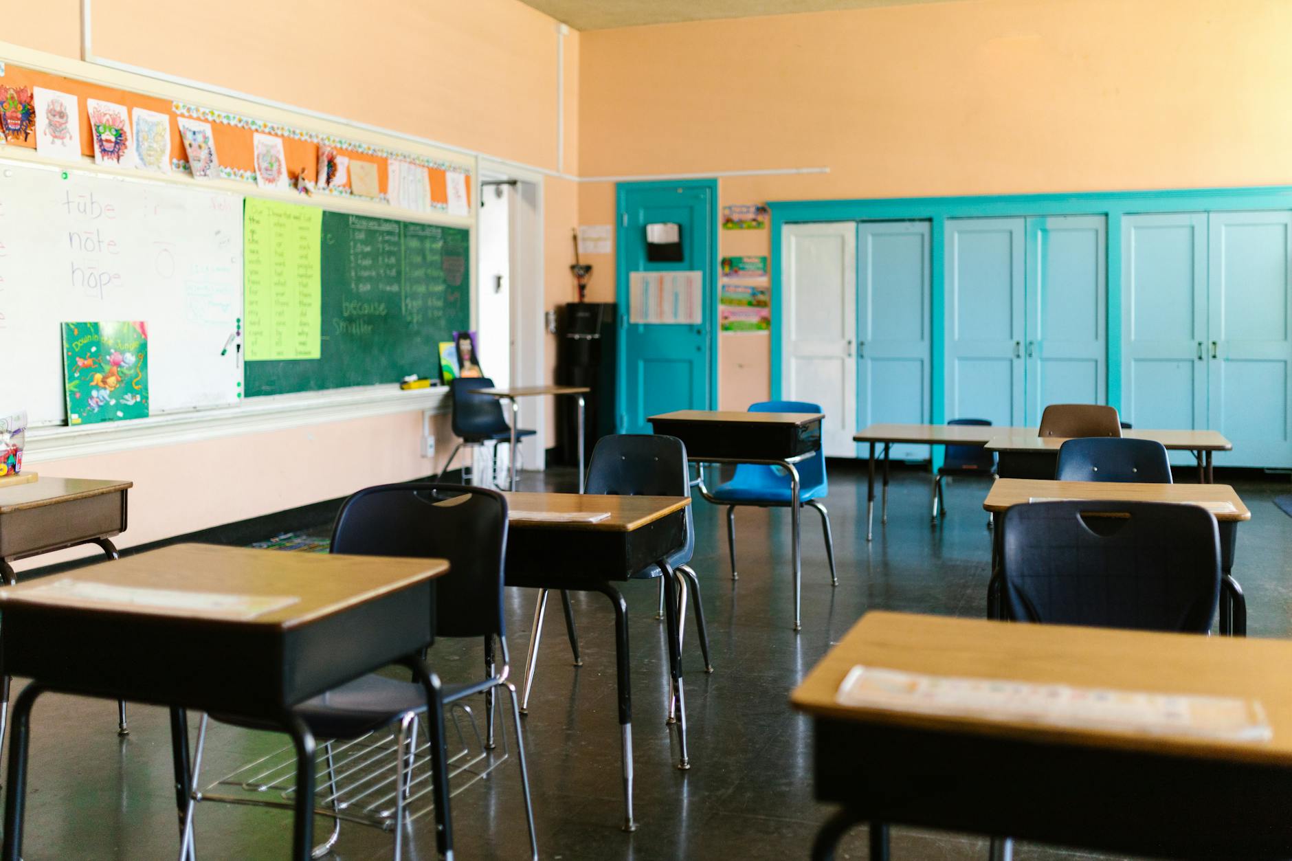 Empty classroom with rows of wooden desks and chairs, representing declining private school enrollment