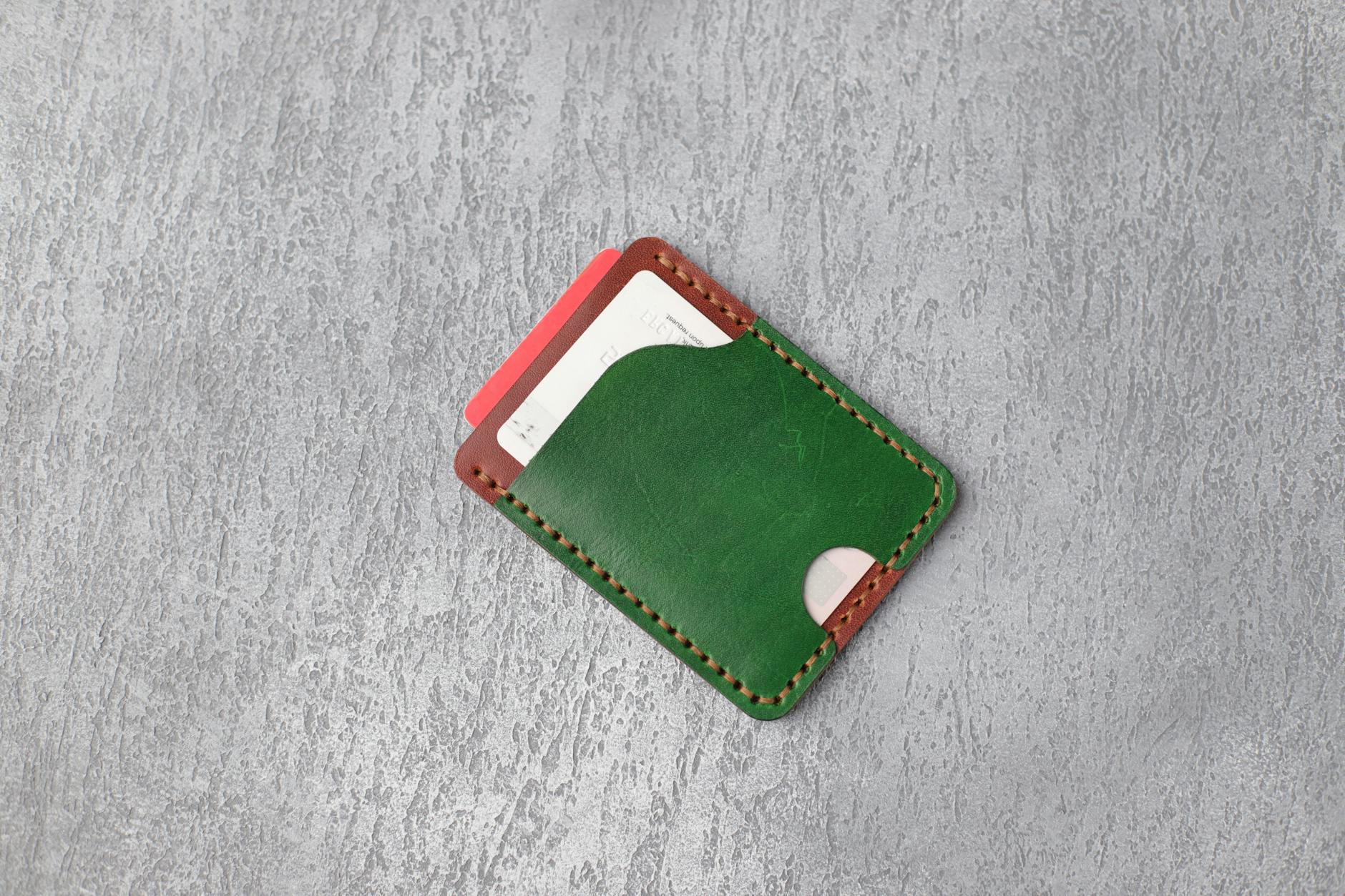 Multiple credit cards arranged in a leather wallet showing various bank logos and card designs