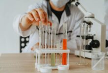 Scientists working in pharmaceutical research laboratory with equipment and test tubes