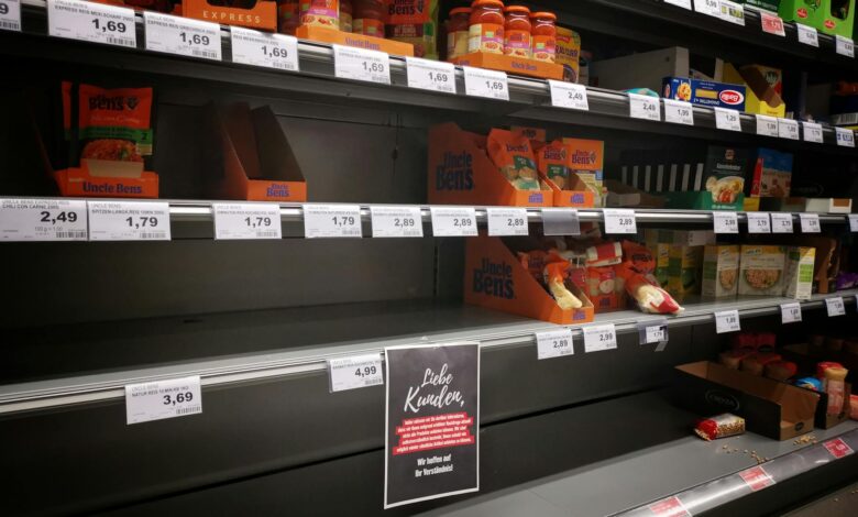 Well-stocked grocery store aisles with various products displayed on shelves