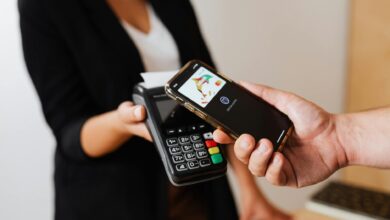 Person using smartphone to make a mobile payment at checkout
