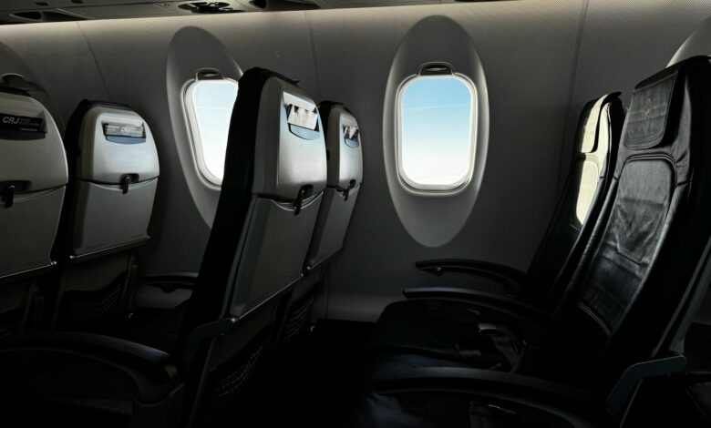 Modern aircraft cabin interior showing business class seating configuration with comfortable leather seats