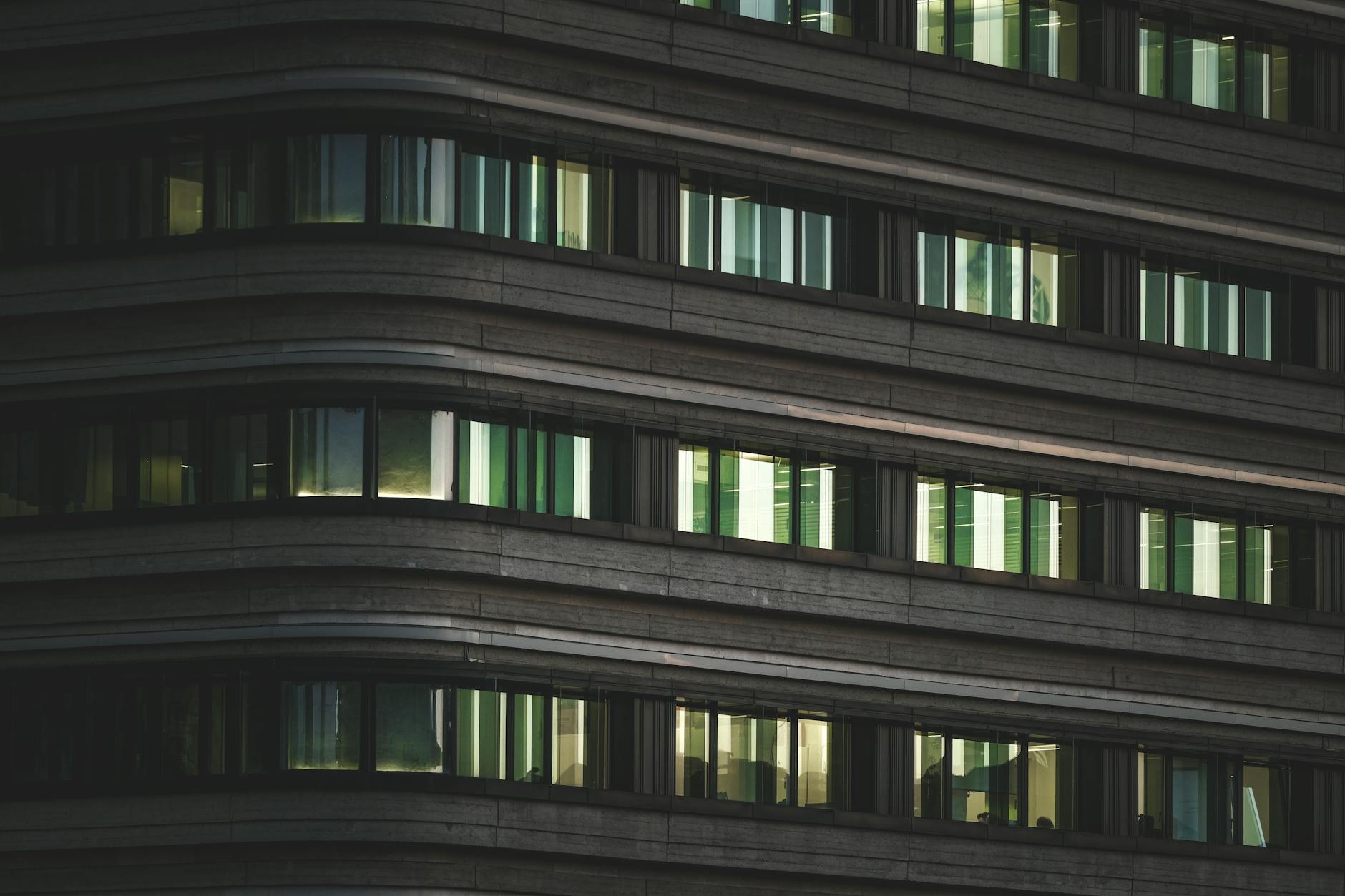 Modern corporate office building with glass facade representing return-to-office mandates