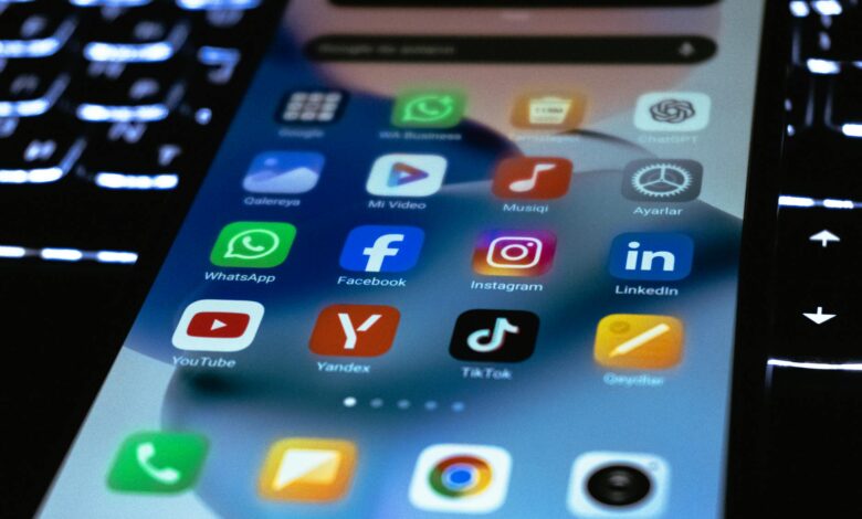 Person holding smartphone displaying social media interface with political content and engagement metrics