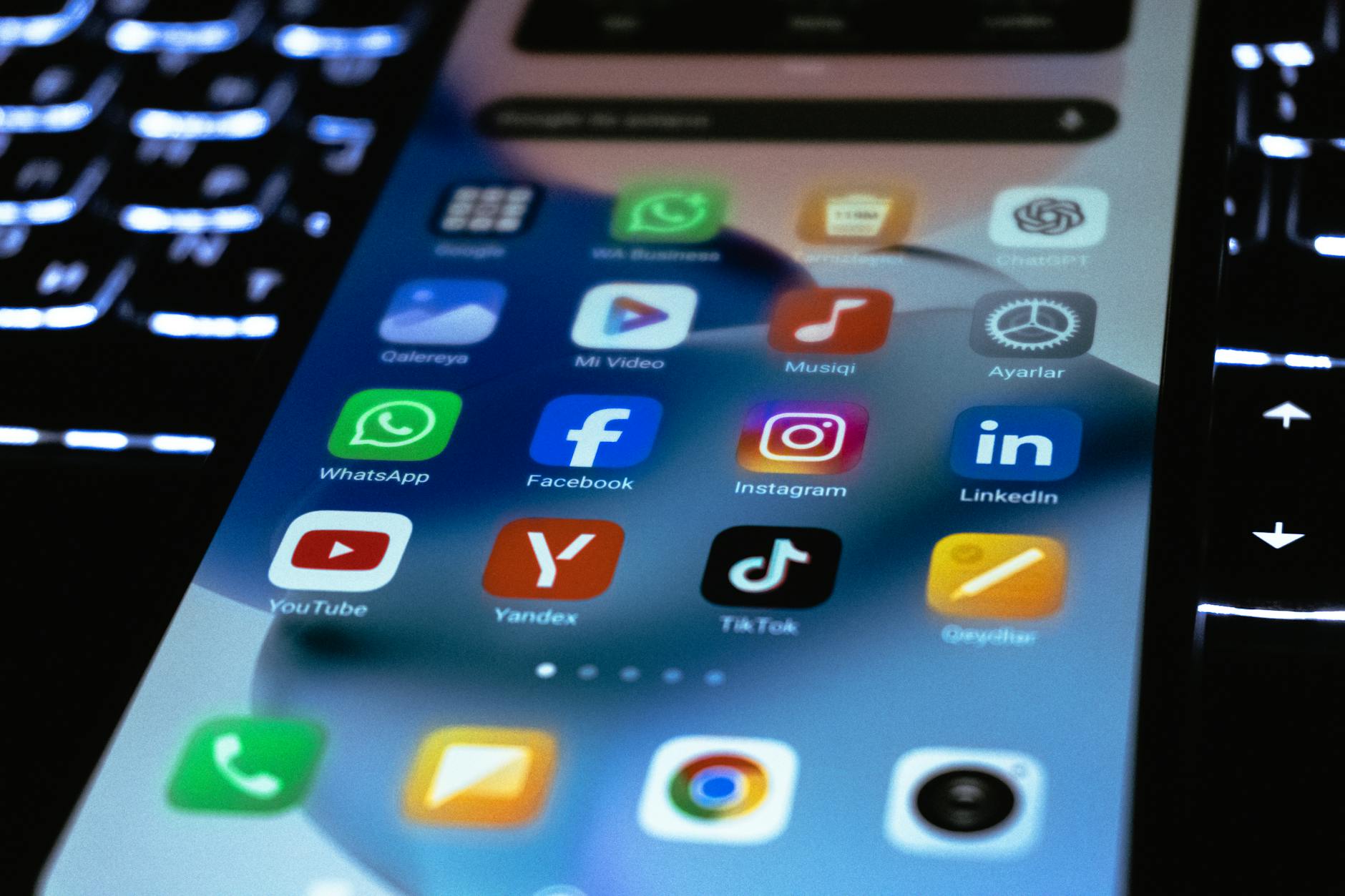 Person holding smartphone displaying social media interface with political content and engagement metrics