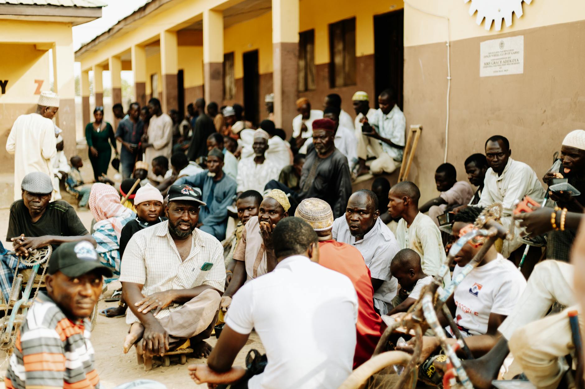 Group of diverse people sitting around table in community center discussion