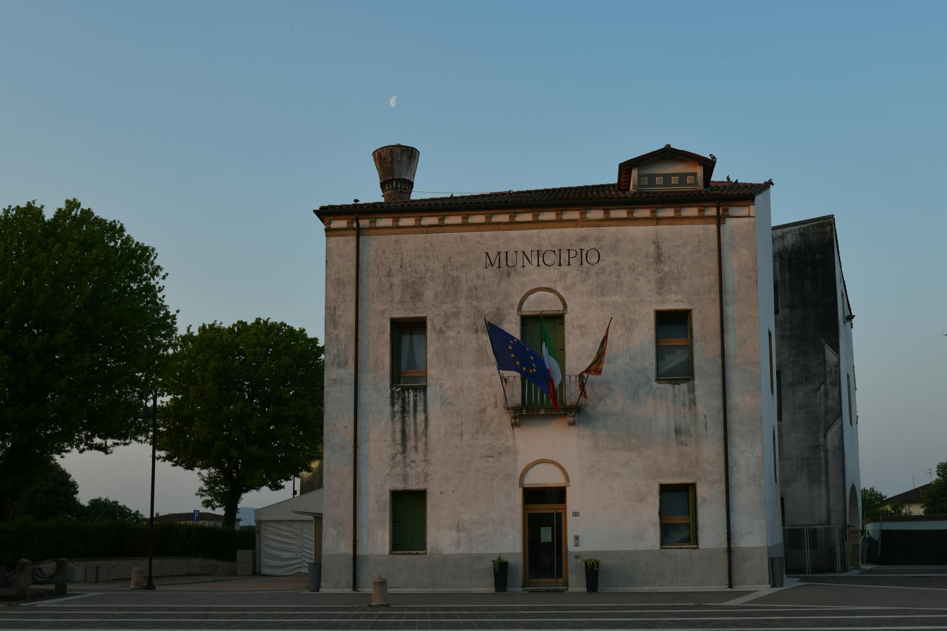 Empty city council chamber with rows of seats and podium