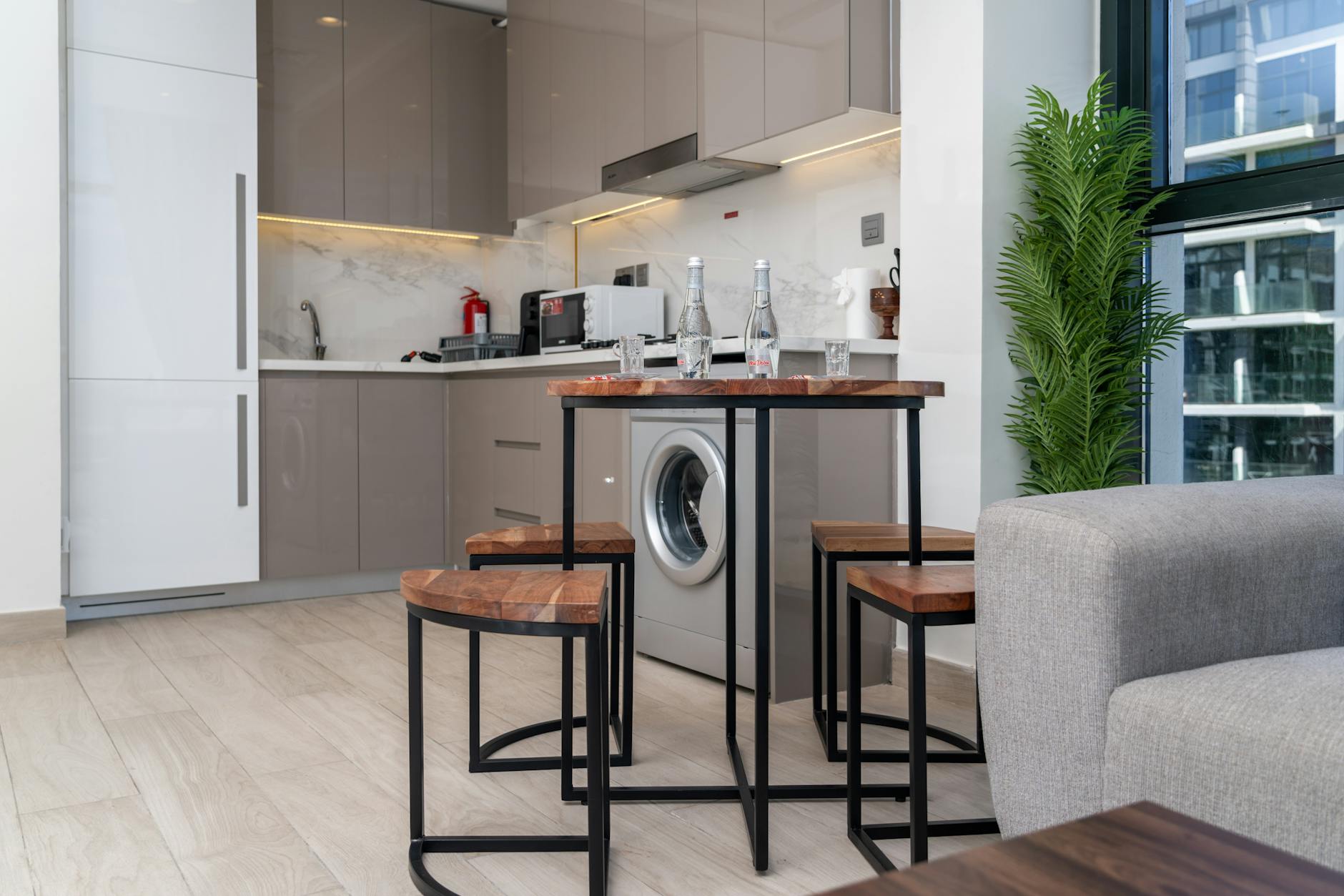 Compact kitchen area with appliances and counter space in extended-stay accommodation