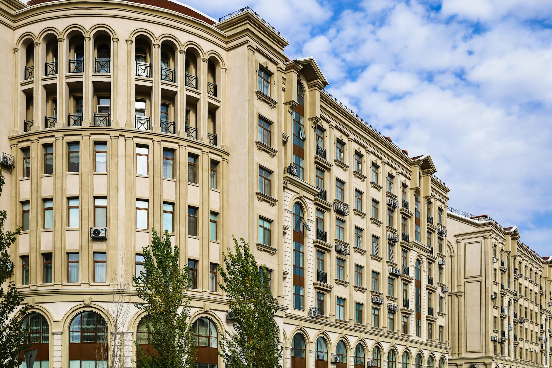 Modern commercial building with clear sky background representing weather-influenced property investment